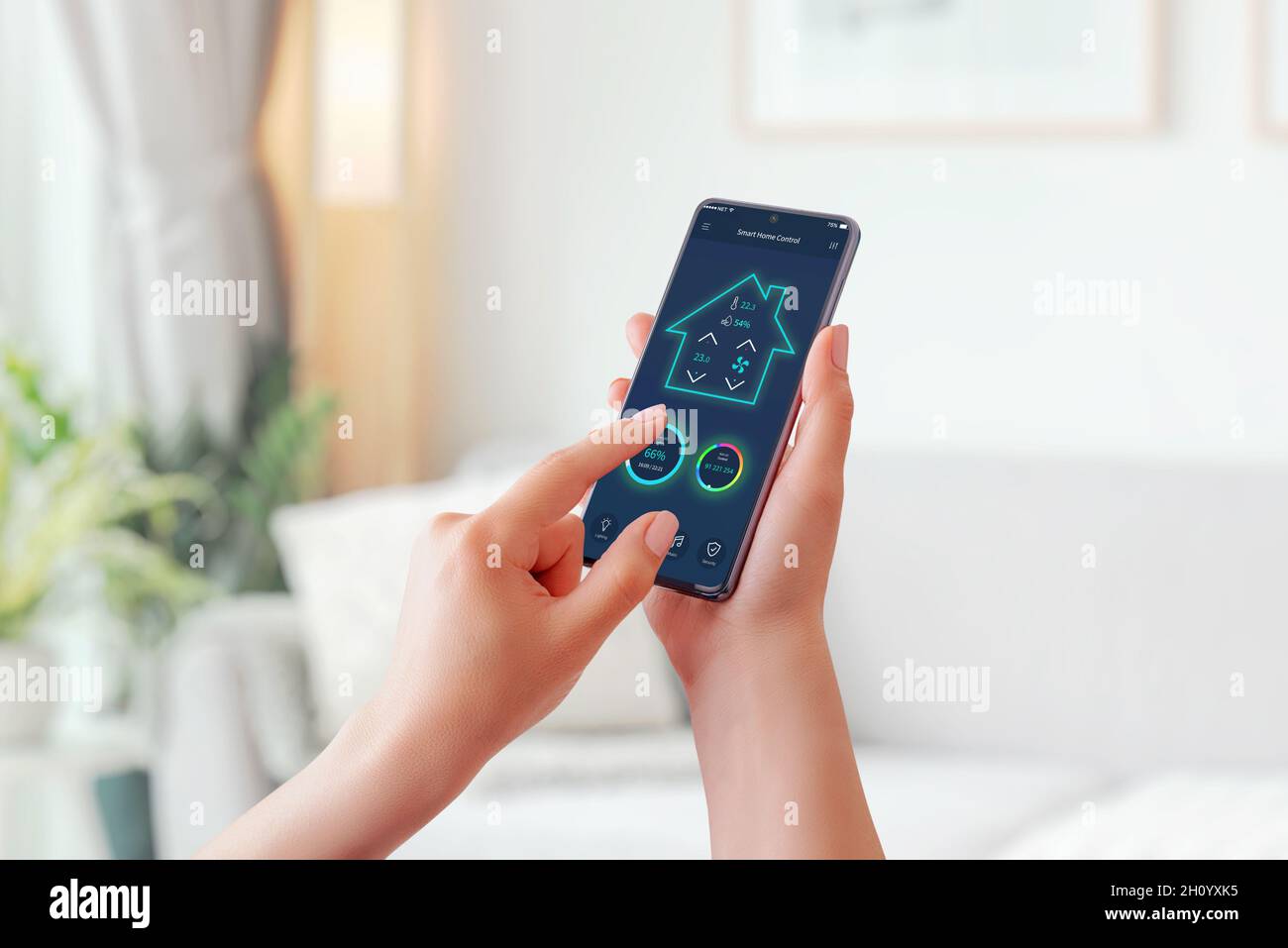 Girl regulates the lighting of her home with smart mobile phone app. Living room interior in background Stock Photo