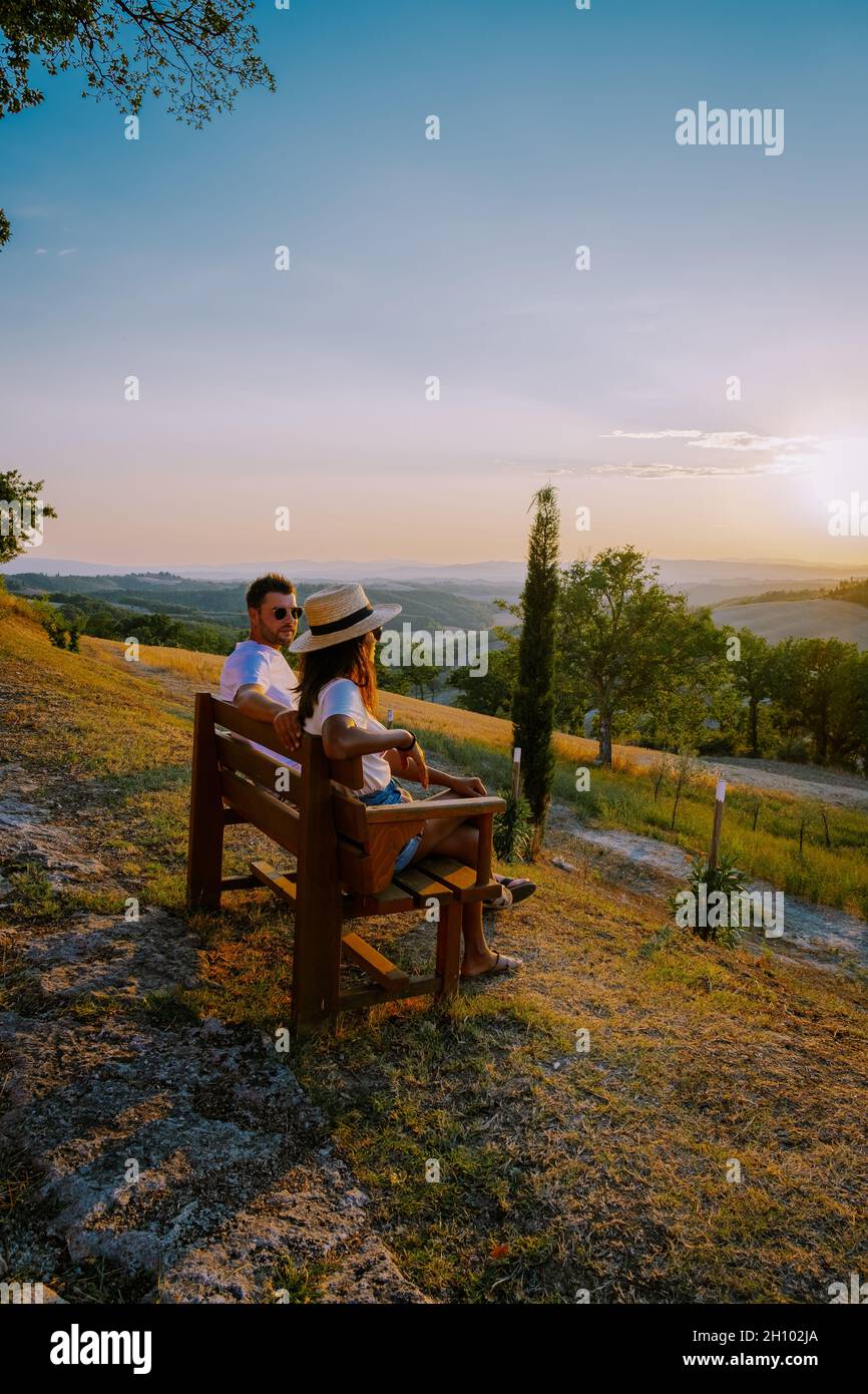 Tuscany Italy, Perfect Road Avenue through cypress trees ideal Tuscan landscape Italy, couple man and woman on vacation in Toscane, couple man and woman in the hills of Toscany Stock Photo