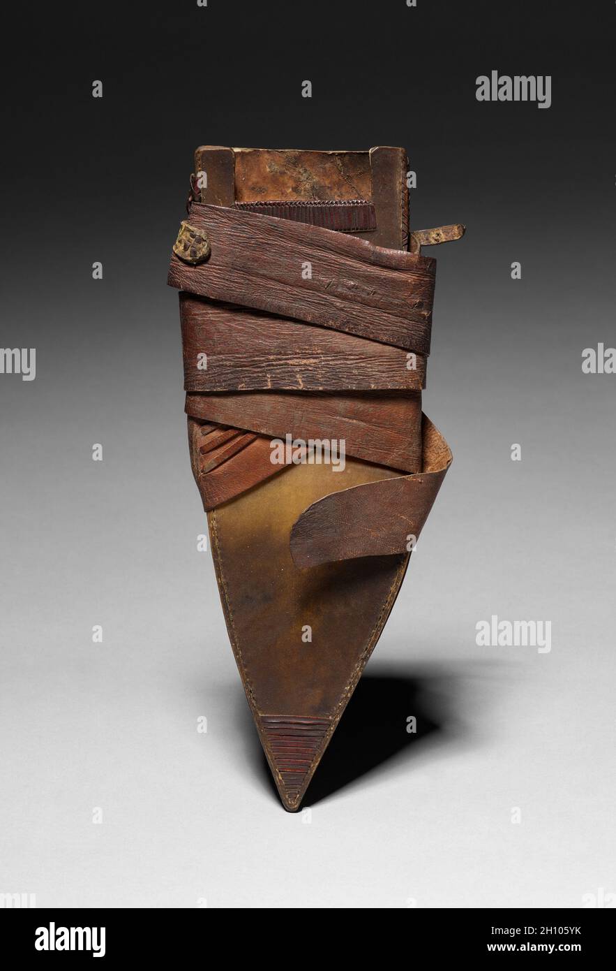Sheath, 1800s. Africa, 19th century. Leather or rawhide; blade: 23.5 cm (9 1/4 in.); scabbard: 10.2 cm (4 in.); knife including handle: 40.7 cm (16 in.). Stock Photo