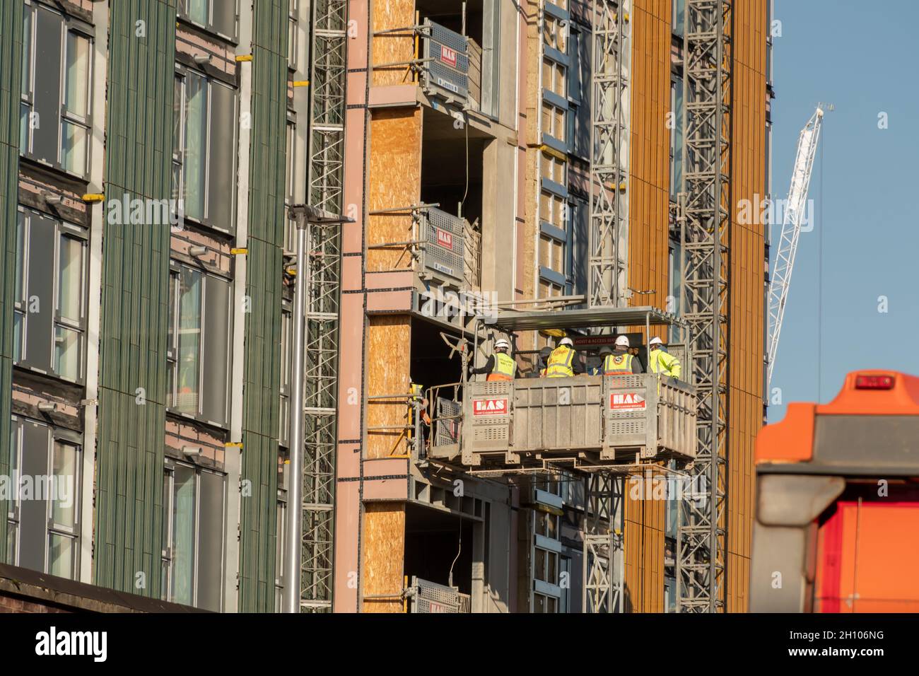 Construction workers on board a construction life at the new Buchanan Wharf development in Tradeston, Glasgow Stock Photo