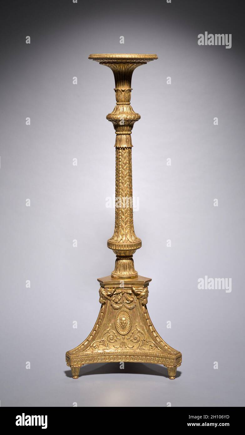 Candle Stand (torchère) (2 of 2), c. 1773. Thomas Chippendale (British, 1718–1779). Gilt-wood, gesso; 154 x 56 x 51 cm (60 5/8 x 22 1/16 x 20 1/16 in.).  This gilded candle stand was made by Thomas Chippendale, the most renowned cabinetmaker in eighteenth-century London, for the grand drawing room of Brocket Hall, a large country house in Hertfordshire, England. With finely carved acanthus leaves, swags, fluting, and oval masks depicting the Roman goddess Diana, this candle stand exhibits Chippendale’s masterful understanding of neoclassical proportion, scale, and ornament. His landmark book o Stock Photo
