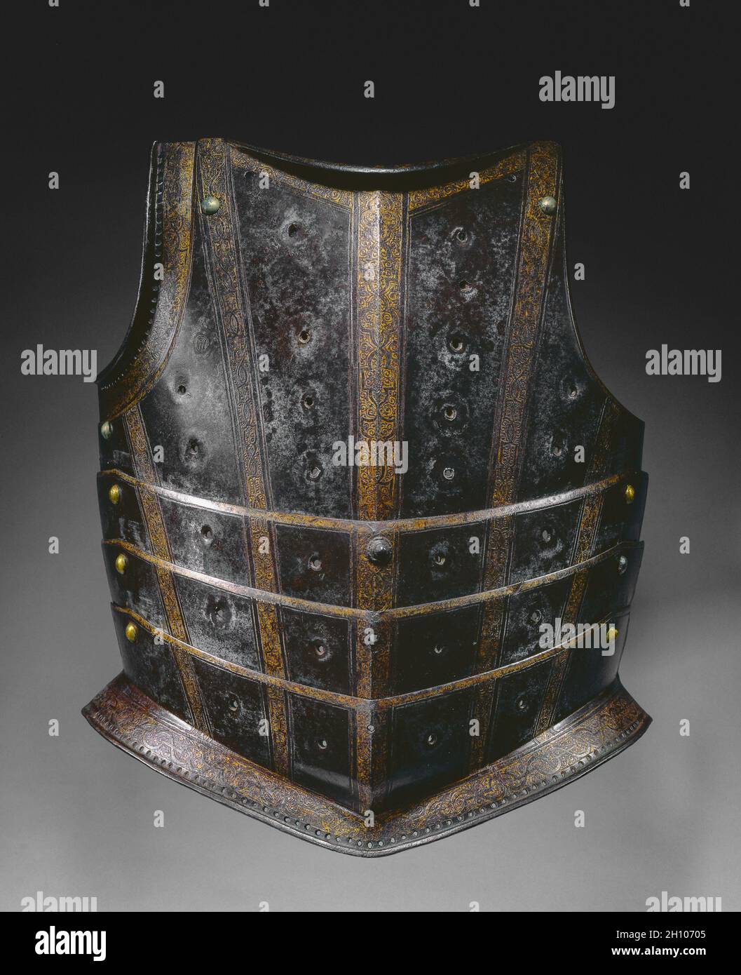 Breastplate from Hussar's Cuirass, c. 1580. Germany, Augsburg or Hungary, 16th century. Steel (originally blued, now russet), etched and gilded strapwork bands; ; overall: 42.3 x 35 cm (16 5/8 x 13 3/4 in.).  This style of breastplate, with its numerous articulating lames, was probably used by a Hungarian hussar, a type of light cavalryman. The steel plates were originally blued-now turned russet-and etched and gilded with strapwork bands. The rows of vertical holes once provided gilt-brass settings for stones or glasspaste jewels. The effect would have suggested the semi-oriental costume and Stock Photo