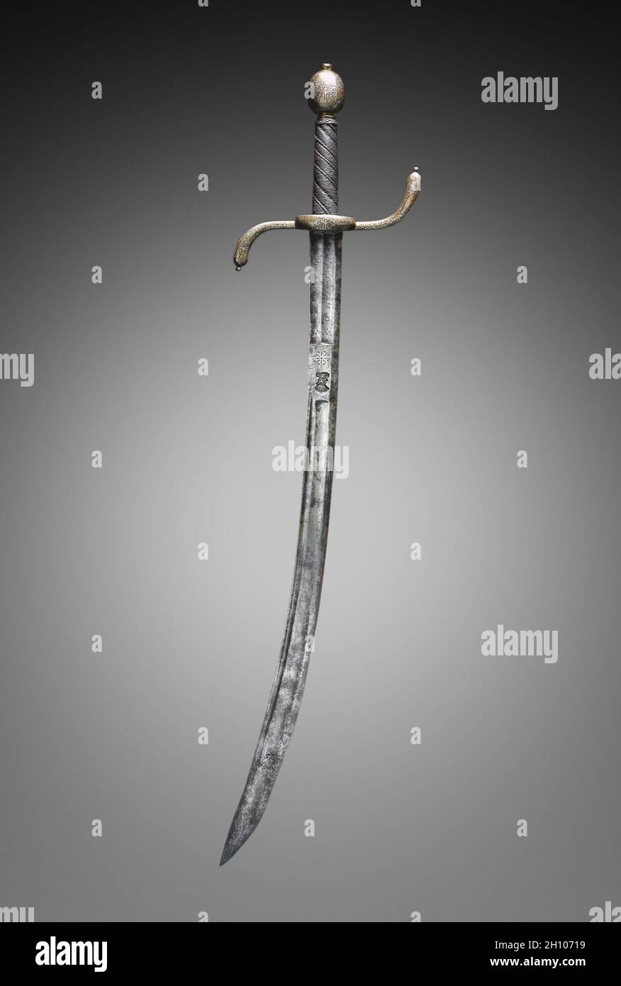 Hanger (Hunting Sword), late 1600s. Jaspar Bongen the Younger (German, active late 1600s). Steel; gold and silver damascened hilt; overall: 73 cm (28 3/4 in.); blade: 57.7 cm (22 11/16 in.); quillions: 17.5 cm (6 7/8 in.).  Damascening, the technique of hammering gold and silver wires into grooves cut to receive them, enlivens this sword's hilt. Further texture was added with wires to improve the user's grip, which allowed him to hunt with more control and accuracy. Hunting was a popular sport among the wealthy and many nobles owned tracts of forest, but peasants were prohibited from hunting o Stock Photo
