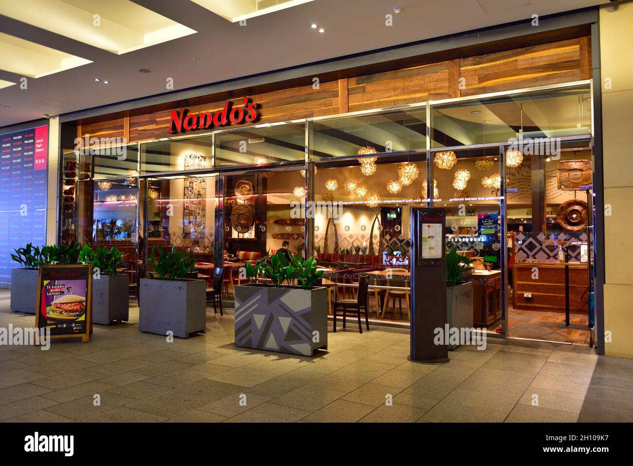 Nando's restaurant  inside the “Mailbox Birmingham” Luxury shopping centre, UK Stock Photo