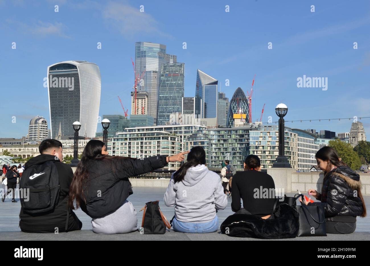 People sitting and watching the City of London skyline as seen from The ...