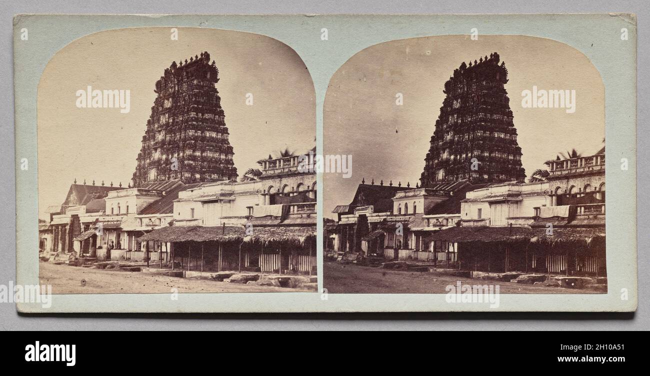Tamil Gateway (Gopura), Tamil Nadu, c. 1860. Unknown, 19th century. Stereoscopic albumen print from glass plate negative; image: 7 x 13.8 cm (2 3/4 x 5 7/16 in.); mounted: 8.3 x 17.3 cm (3 1/4 x 6 13/16 in.).  A stereograph, when seen through a viewer, produces the illusion of a three-dimensional scene and creates a “you-are-there” sensation. This stereo view documents a Hindu temple in the southern Indian state of Tamil Nadu. The high gopura or gatehouse leading into the temple precinct is characteristic of the Dravidian temples found in that region. Stock Photo