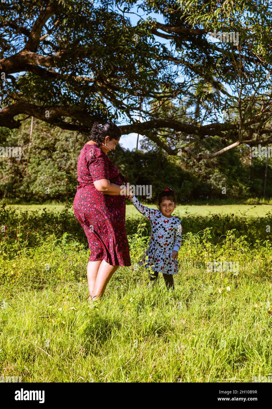 Margao Goa India- October 9th 2021: Asian mother and asian toddler daughter spending time outdoors. Happy maternity scene of mother and toddler Stock Photo
