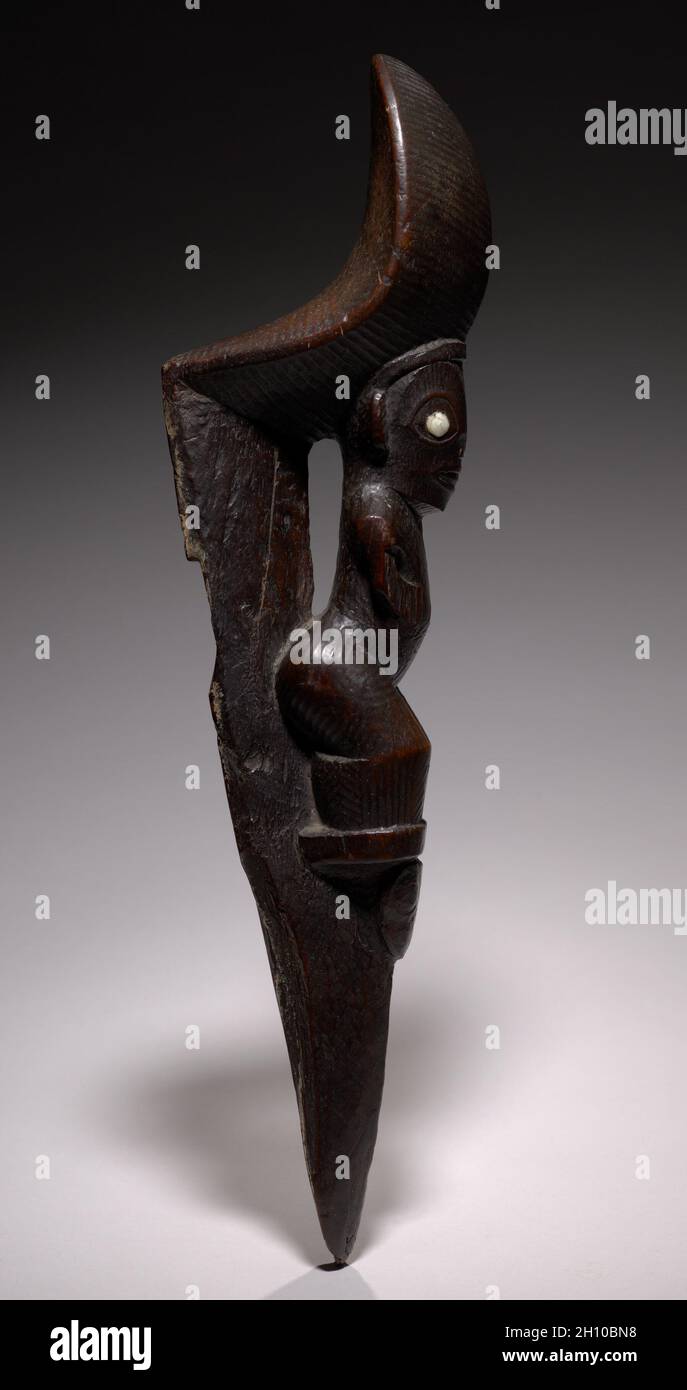 Stilt Footrest, early 1800s. Polynesia, Marquesas Islands, 19th century. Wood; overall: 40 x 7.7 x 11.8 cm (15 3/4 x 3 1/16 x 4 5/8 in.).  Stilt walking and knockdown stilt contests were favorite forms of amusement and competition on the Marquesas Islands. The decorated footrest was secured to a six-foot stilt pole by wrapping sennit fiber cord through a wide slit at the carved figure's back and around the pointed end. Champion stilt walkers competed with those from other tribes during great festivals. Special artists carved the footrests from hardwood and cured them in the mud of a taro patch Stock Photo