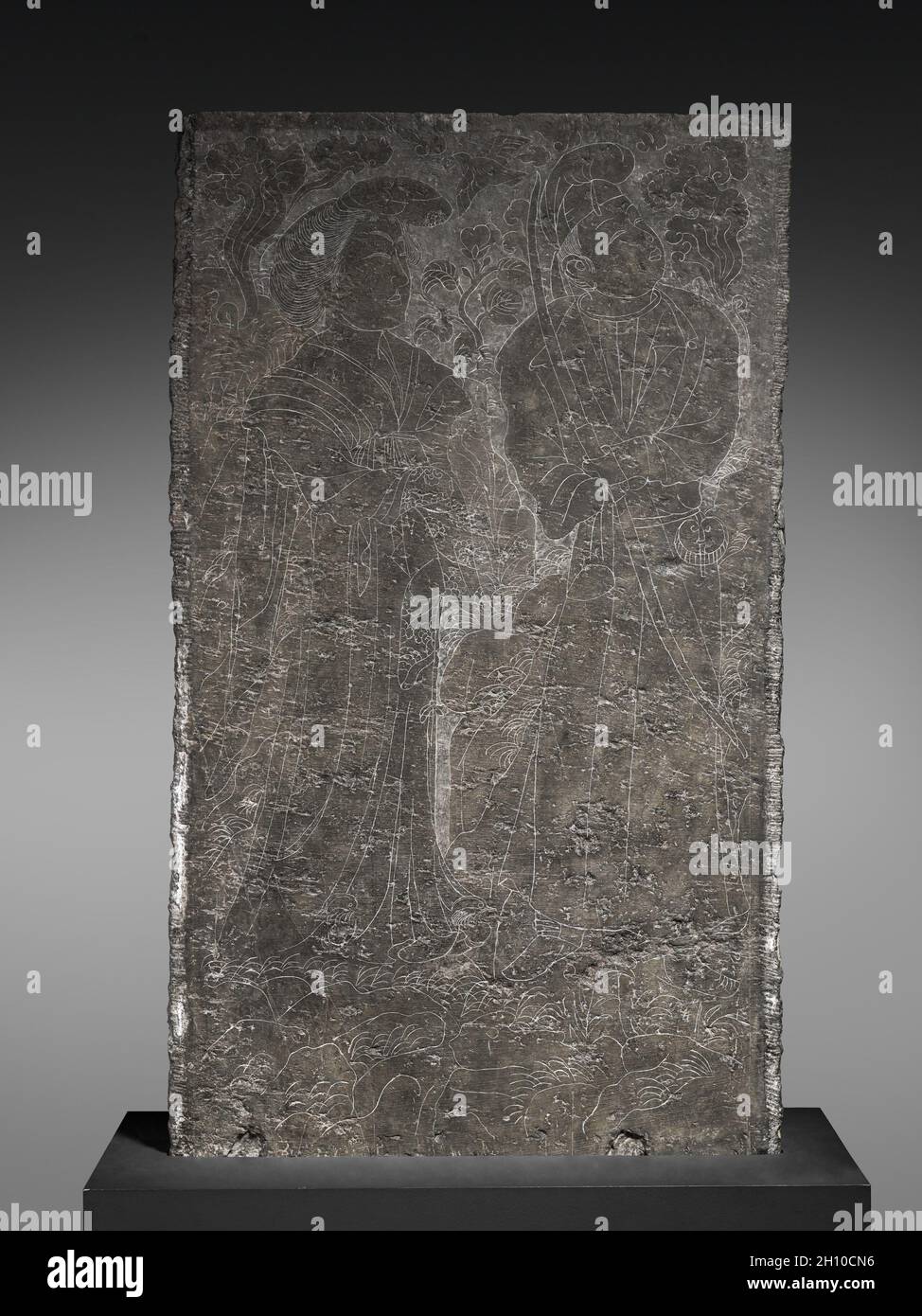 Sarcophagus Panel, early 8th Century. China, Tang dynasty (618-907). Limestone; overall: 119 x 69 x 10 cm (46 7/8 x 27 3/16 x 3 15/16 in.).  This slab originally formed the 'window' panel of a coffin encasement constructed to resemble a one-story house. The dwarfs bowing respectfully under the vertical lattice window, as well as the court lady and archer engraved on the reverse, reflect the style of contemporary figure painting. Complete structures with similar decor have been excavated from tombs in the Tang imperial cemetery near Sian in northwest China. Stock Photo