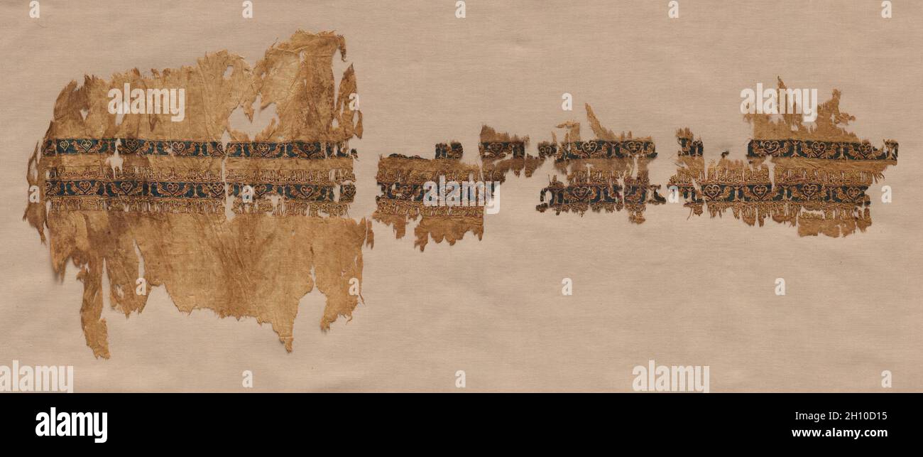 Tiraz with gold, probably from a wide sleeve, 1013-1020. Egypt, Fatimid period, reign of Caliph al-Hakim, 1013–20. Plain weave with inwoven tapestry weave: linen, silk, and gold filé; overall: 23.5 x 62.3 cm (9 1/4 x 24 1/2 in.).  This textile with expensive gold foil is among the rarest surviving examples among thousands of medieval textiles with historic or generic inscriptions in Arabic, known as tiraz. Tiraz were 'emblems of dignity,' the prerogative of sovereigns and those they wished to honor. This inscription is masterful. The tall letters are woven with silk thread on only two warps in Stock Photo