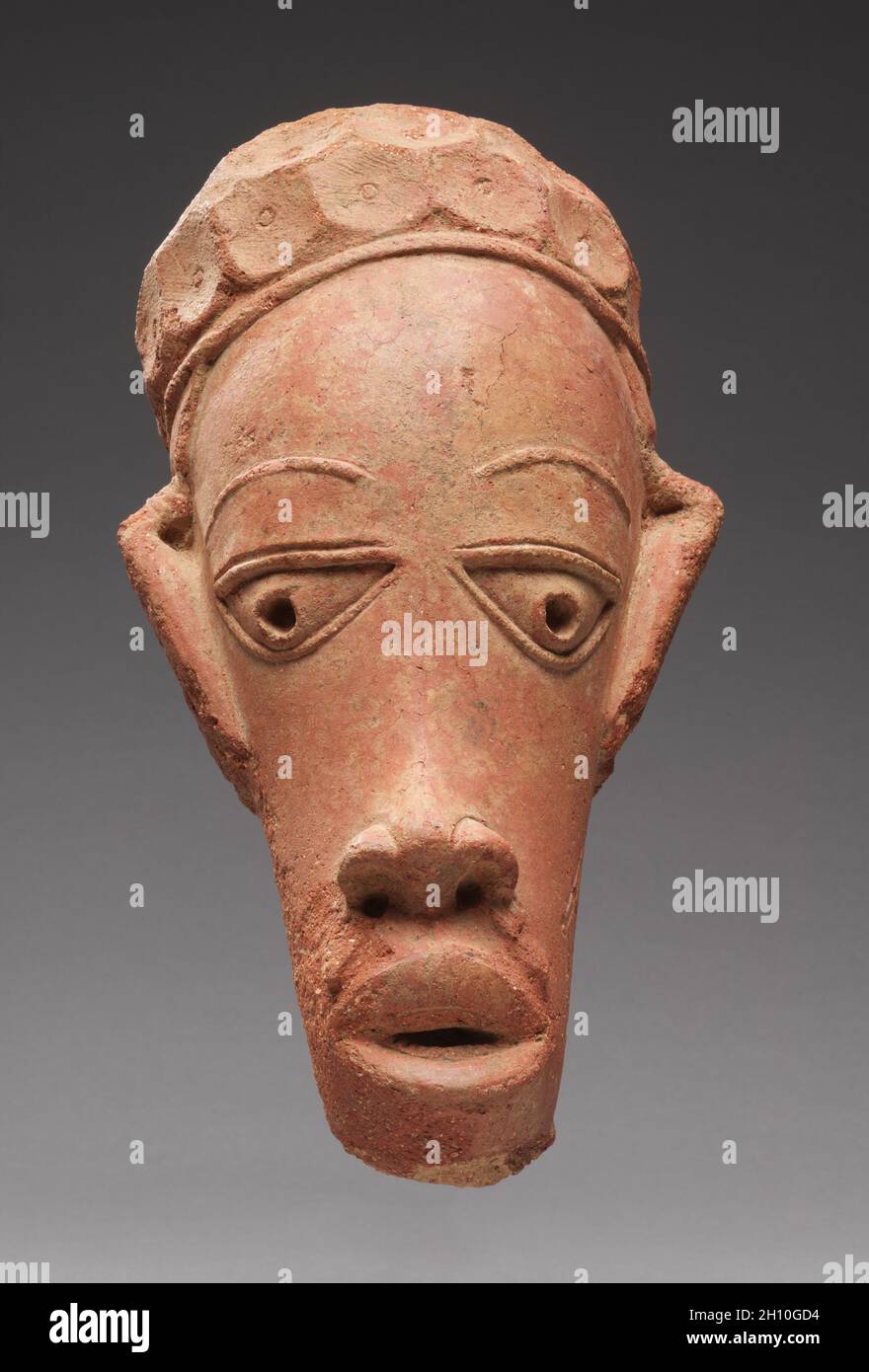 Head, 600 BC-AD 250. Africa, West Africa, Nigeria, Nok-culture style region, unknown maker. Terracotta; overall: 38.2 x 20 cm (15 1/16 x 7 7/8 in.). Stock Photo