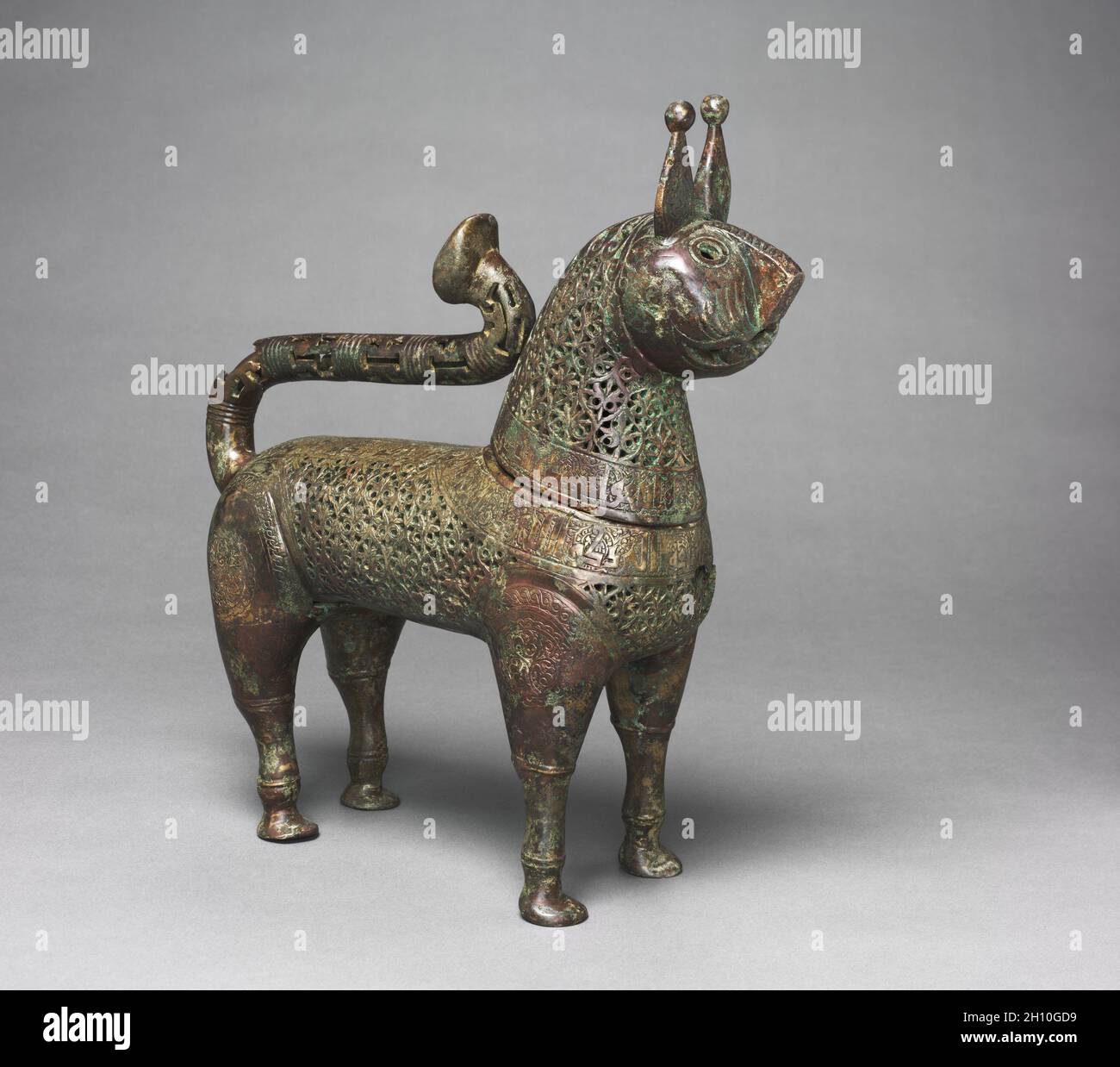 Feline Incense Burner, 1150–1200. Iran, Khurasan, Seljuq period of Iran (1037–1194). Copper alloy, cast, engraved, chased, and pierced; overall: 35.5 x 11 x 32.5 cm (14 x 4 5/16 x 12 13/16 in.); head: 17.8 x 9.5 x 12.5 cm (7 x 3 3/4 x 4 15/16 in.). Stock Photo