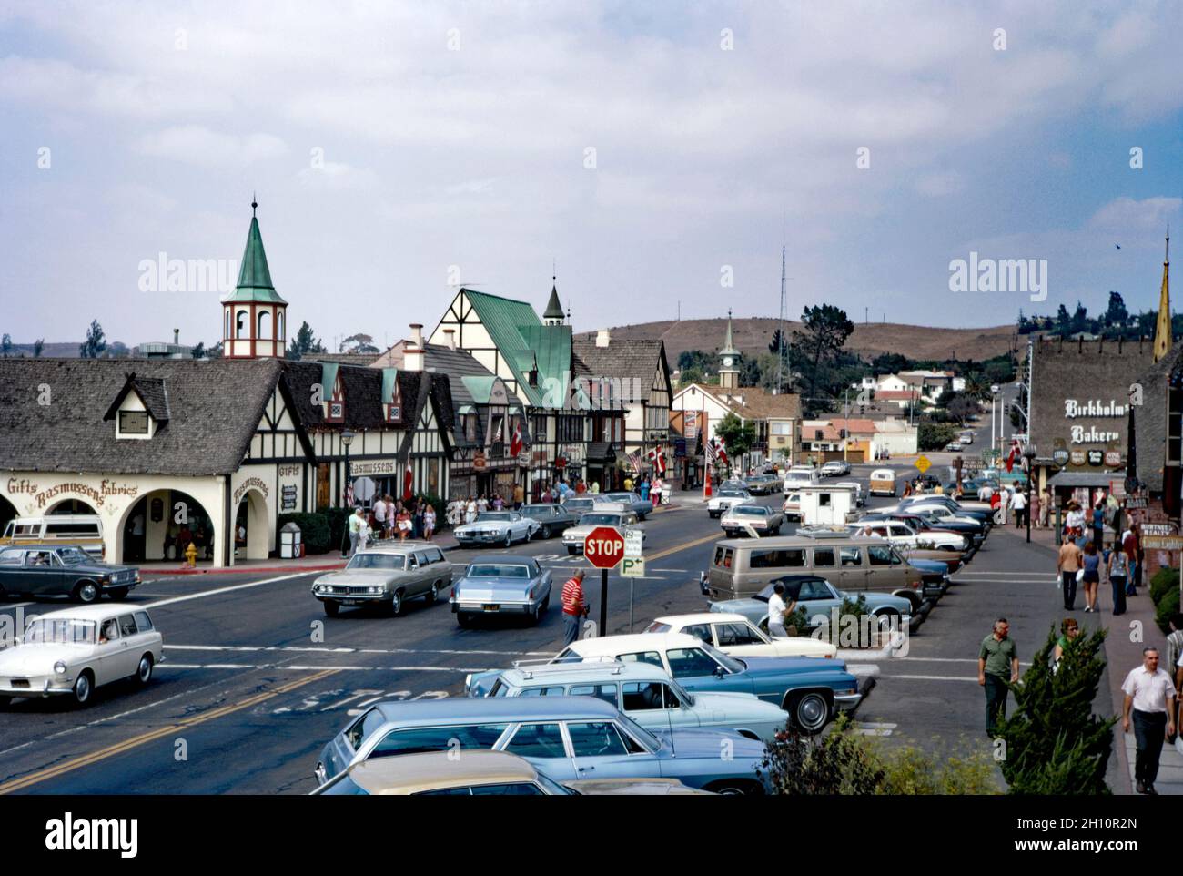 A view down the main street of Solvang in the Santa Ynez Valley, Santa Barbara County, California, USA in 1972. Solvang is often dubbed ‘The Danish Capital of America’ (Solvang is Danish for ‘sunny field’). A small community grew up around the mission of Santa Inés in 1804. In 1911 a new settlement was founded around the mission by a group of Danish-Americans who purchased land to establish a Danish community. It now has distinctive Danish-themed architecture – the town attracts many tourists from the Nordic countries – a vintage 1970s photograph. Stock Photo