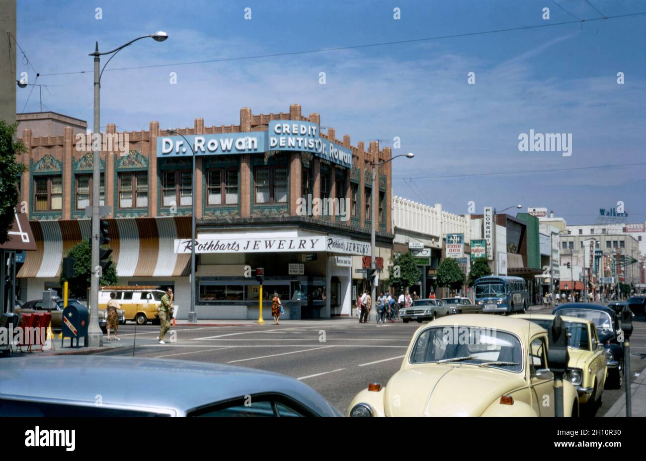 A view looking down Pine Avenue, Long Beach, California, USA in 1972. The city is located within the Los Angeles metropolitan area. This is one of the main shopping streets downtown. Many of the older buildings still remain, including the one on the corner housing a dental practice and jeweller’s shop. This image is from an old American amateur Kodak colour transparency – a vintage 1970s photograph. Stock Photo