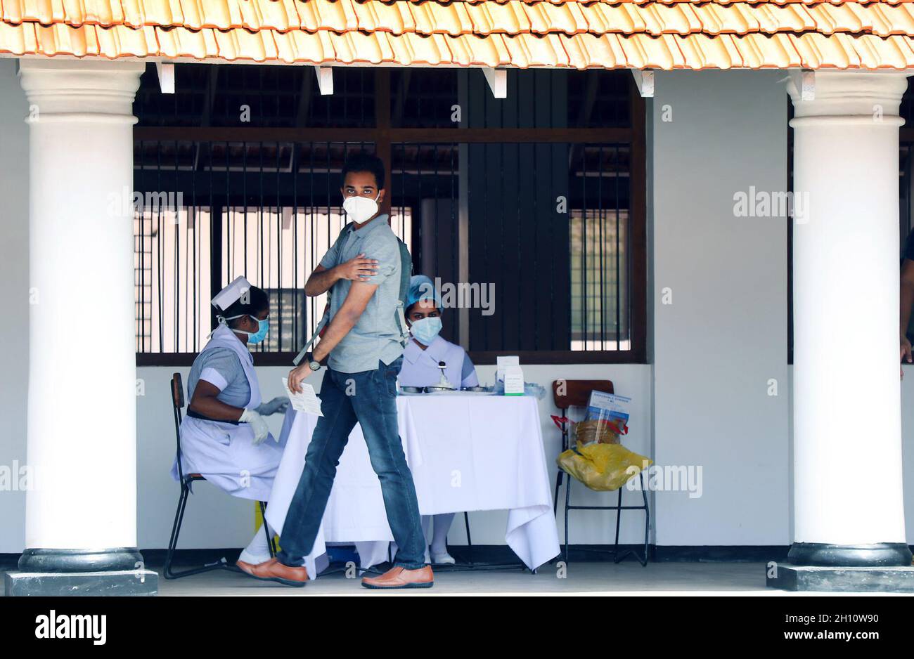 Colombo, Sri Lanka. 15th Oct, 2021. A student walks after getting a vaccine COVID-19 in Colombo, Sri Lanka, Oct. 15, 2021. Sri Lankan health authorities on Friday began administering the COVID-19 vaccines on school students between the ages of 18 and 19 with the Pfizer doses amidst a large-scale vaccination program ongoing in the country since January. Credit: Ajith Perera/Xinhua/Alamy Live News Stock Photo
