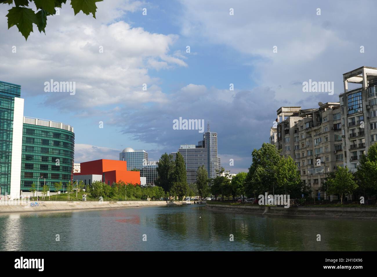 Office and residential buildings on Dambovita river shores in sunny day in Bucharest with Romanian Chamber of Commerce and Industry in the center Stock Photo