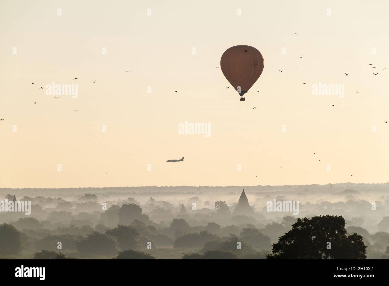 Balloon over Bagan, landing airplane and the skyline of its temples, Myanmar Stock Photo