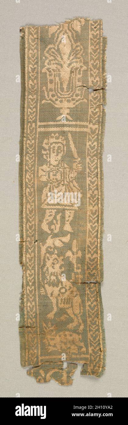 Silk Decorative Tunic Band with a Hunter, 700s. Egypt or Syria, Umayyad period (661–750) or Abbasid period (750–1258). Silk: complementary weft-faced twill with inner warps (samit); overall: 27.3 x 6.7 cm (10 3/4 x 2 5/8 in.); mounted: 34.9 x 14.3 cm (13 3/4 x 5 5/8 in.). Stock Photo