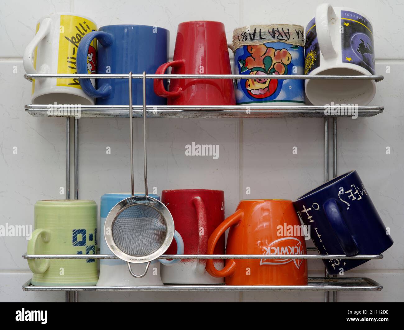 Teacups on the drying shelf Stock Photo