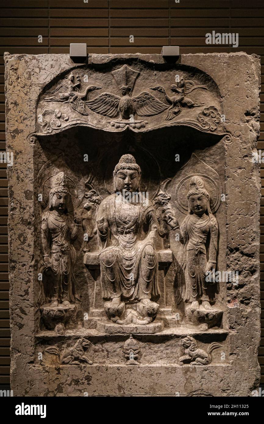 ancient art limestone buddha triad in a niche statue image in 8th century, Tang Dynasty, Baoqingsi temple, Xi’an, Shaanxi province, China Stock Photo