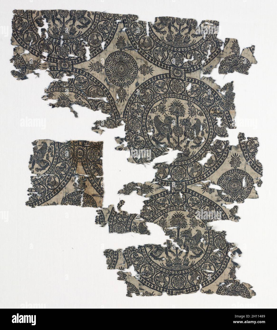 Fragment with Griffins in Roundels, before 1982. Iran or Iraq, in the style of the Seljuq period (1037–1194). Silk: lampas weave; overall: 35.5 x 30.5 cm (14 x 12 in.). Stock Photo