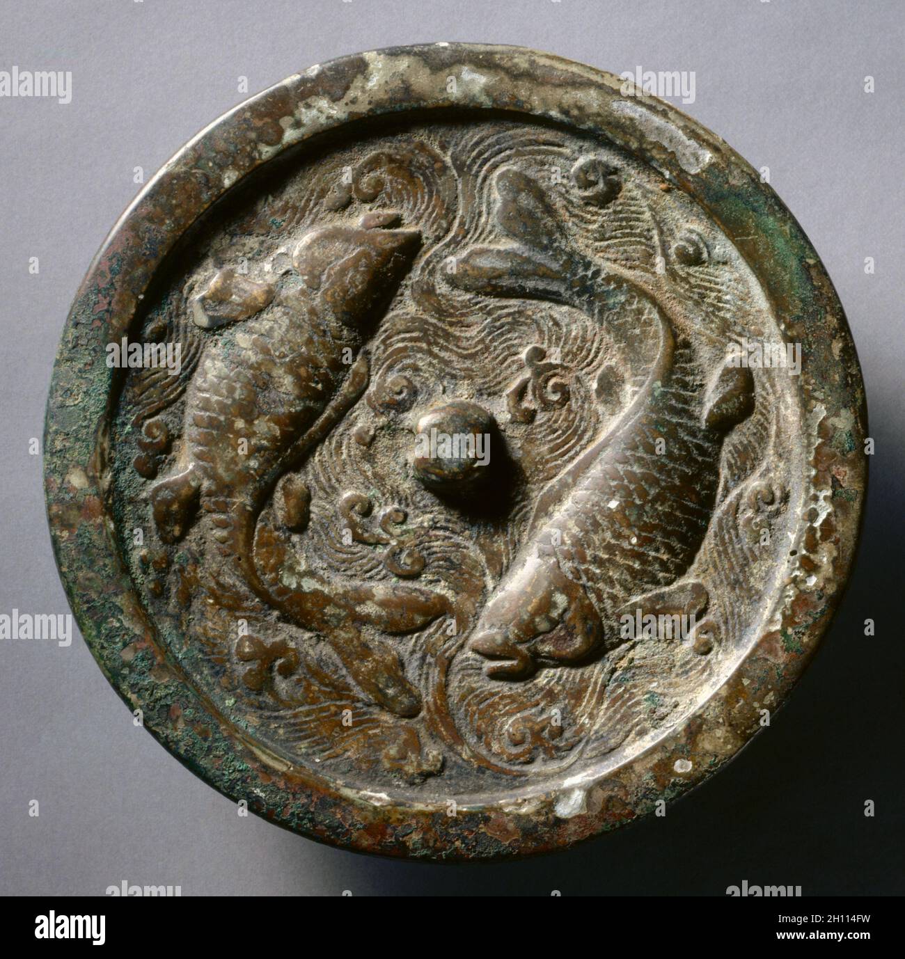 Mirror with Twin Carp, c. 1200-25. China, Jin dynasty (1115-1234). Bronze; diameter: 17.9 cm (7 1/16 in.); overall: 0.9 cm (3/8 in.); rim: 0.7 cm (1/4 in.). Stock Photo