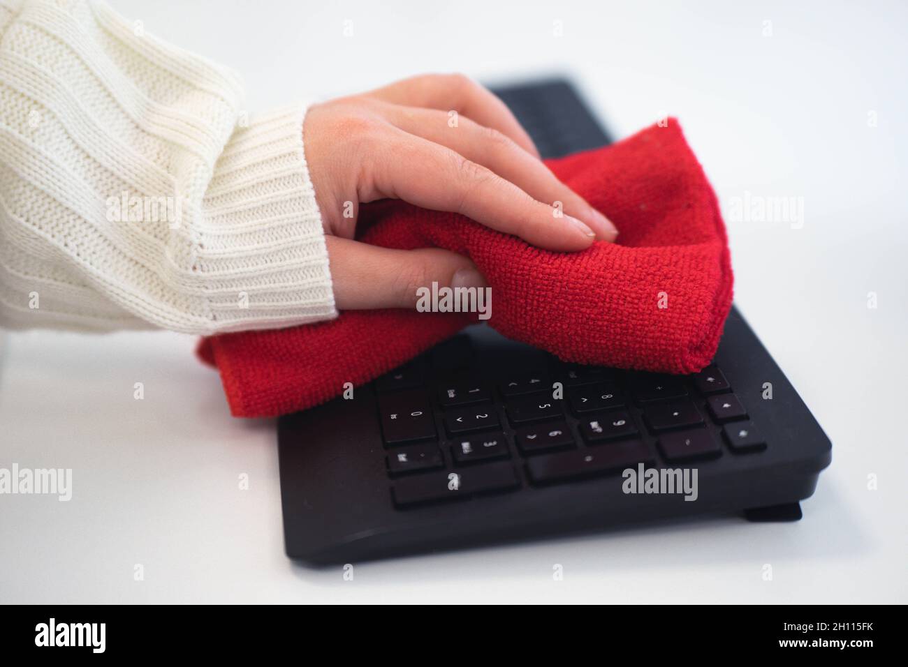 Cleaning keyboard with a microfiber cloth Stock Photo Alamy