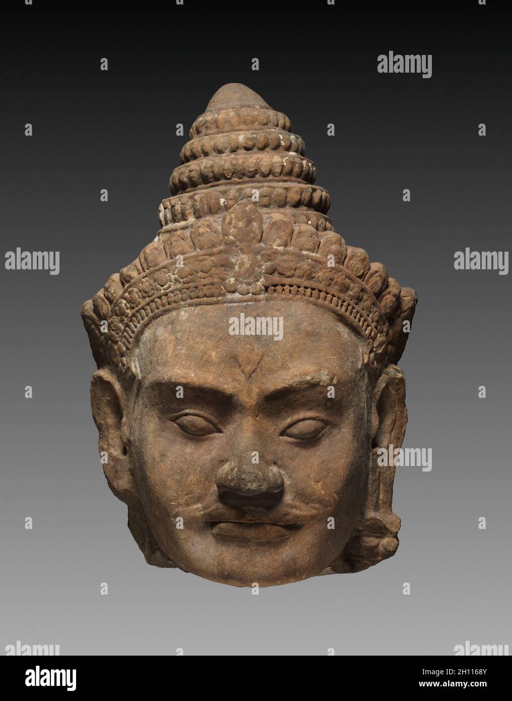 Colossal Head of a Deva, c. 1200. Cambodia, Angkor, c. early 13th century. Sandstone; overall: 71.3 x 50 x 47 cm (28 1/16 x 19 11/16 x 18 1/2 in.). Stock Photo