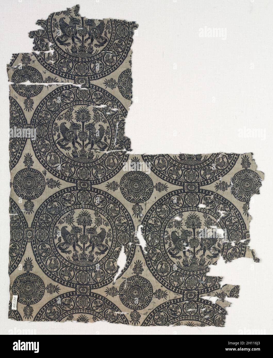 Fragments with Griffins in Roundels, before 1966. Iran or Iraq, in the style of the Seljuq period (1037–1194). Silk: lampas weave; overall: 41 x 32.8 cm (16 1/8 x 12 15/16 in.). Stock Photo