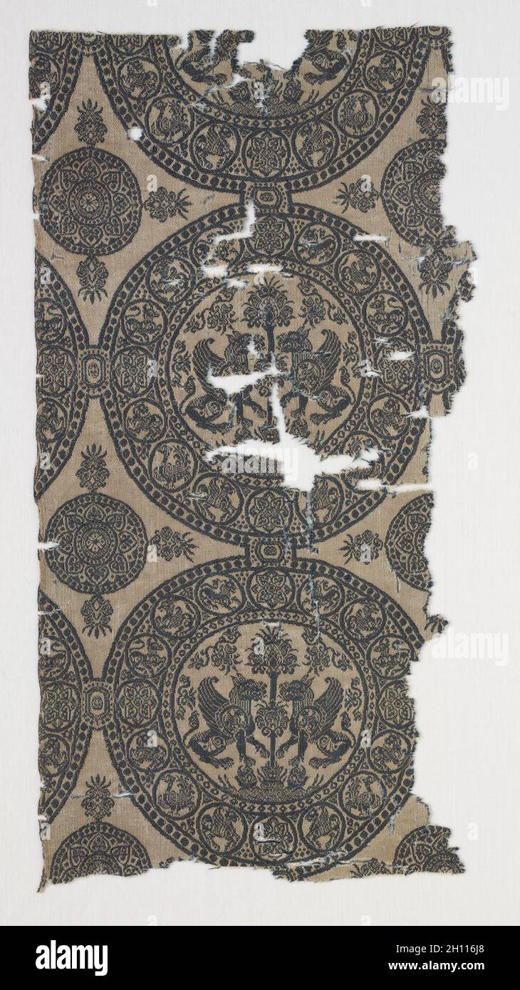 Fragments with Griffins in Roundels, before 1966. Iran or Iraq, in the style of the Seljuq period (1037–1194). Silk: lampas weave; overall: 34.2 x 17 cm (13 7/16 x 6 11/16 in.). Stock Photo