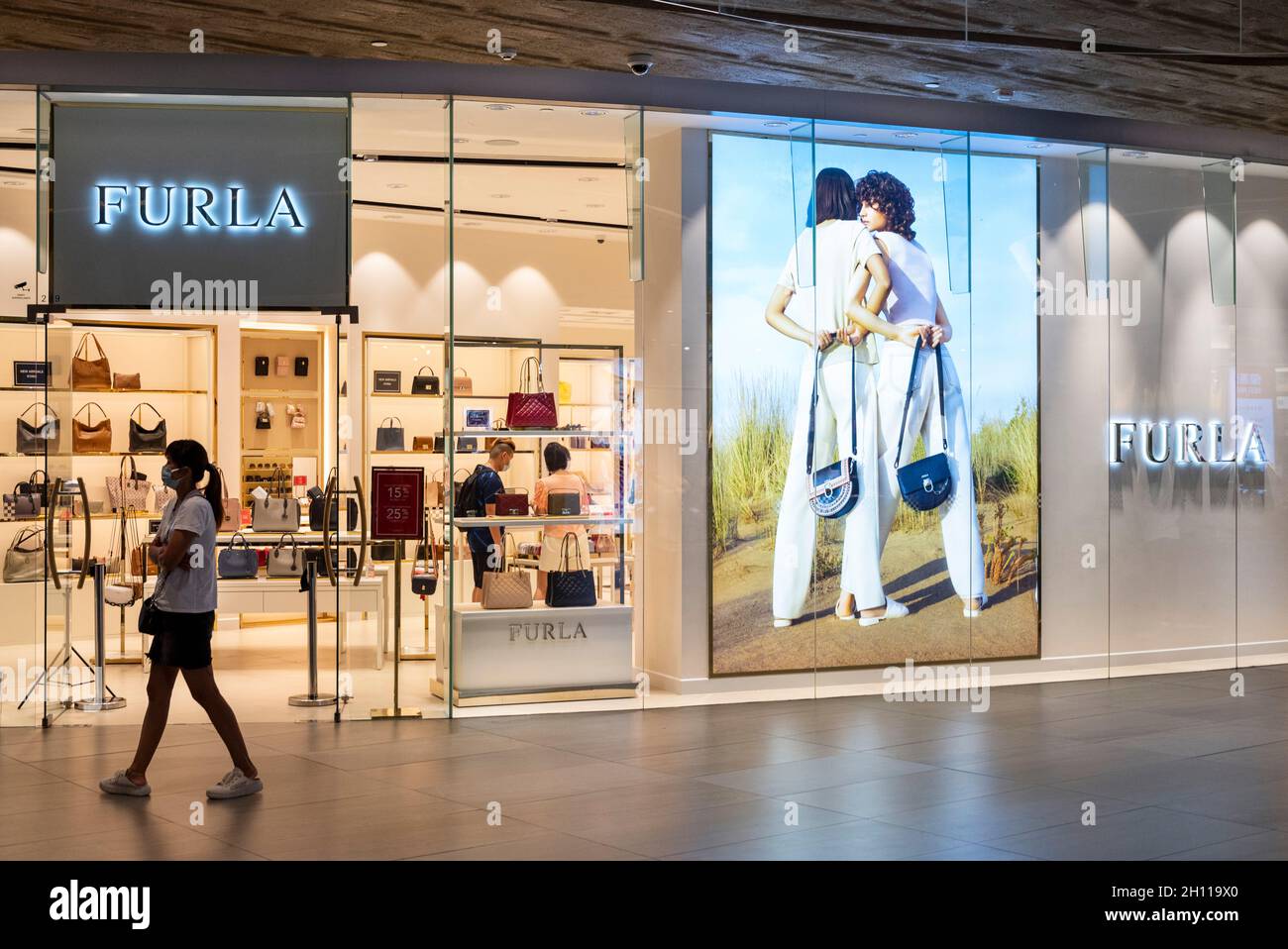Hong Kong, China. 07th Oct, 2021. A shopper walks past the Italian clothing luxury brand Furla store at Tung Chung district in Hong Kong. Credit: SOPA Images Limited/Alamy Live News Stock Photo
