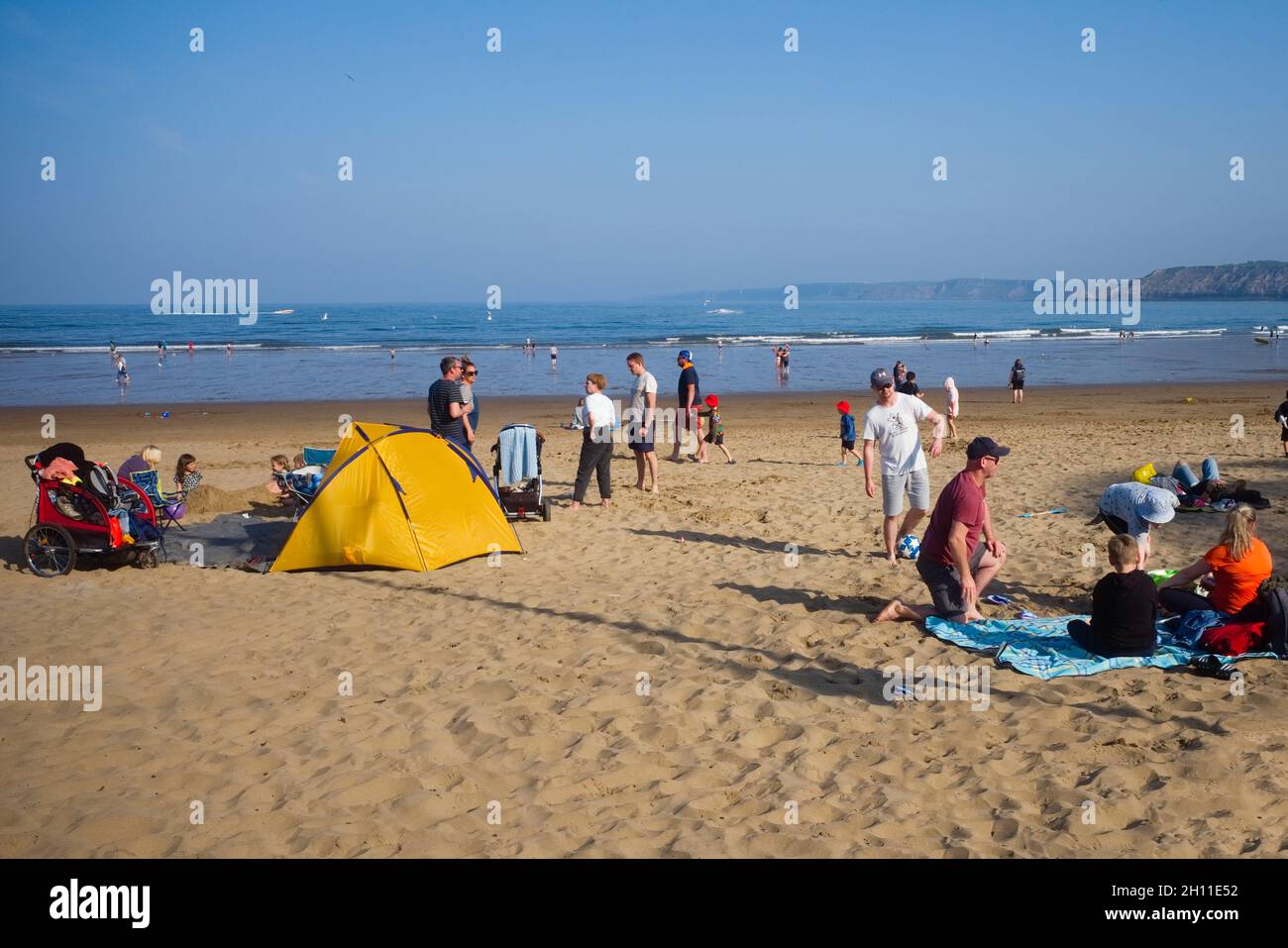 Families enjoying themselves at half term during covid times on Scarborough beach Stock Photo