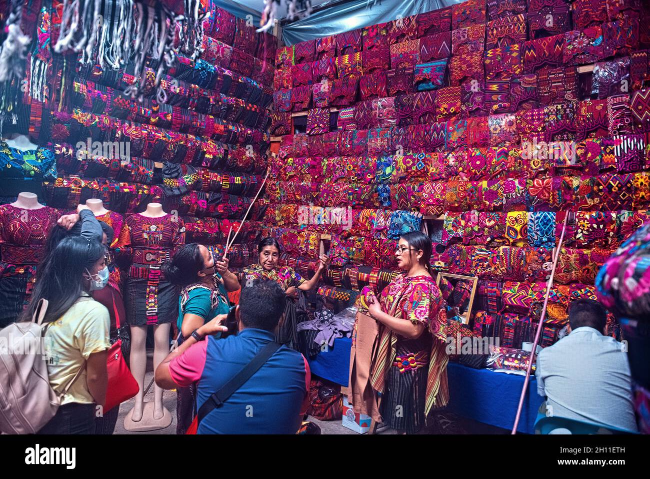Mayan women shopping for textiles at the Sunday Market in Chichicastenango, Guatemala Stock Photo