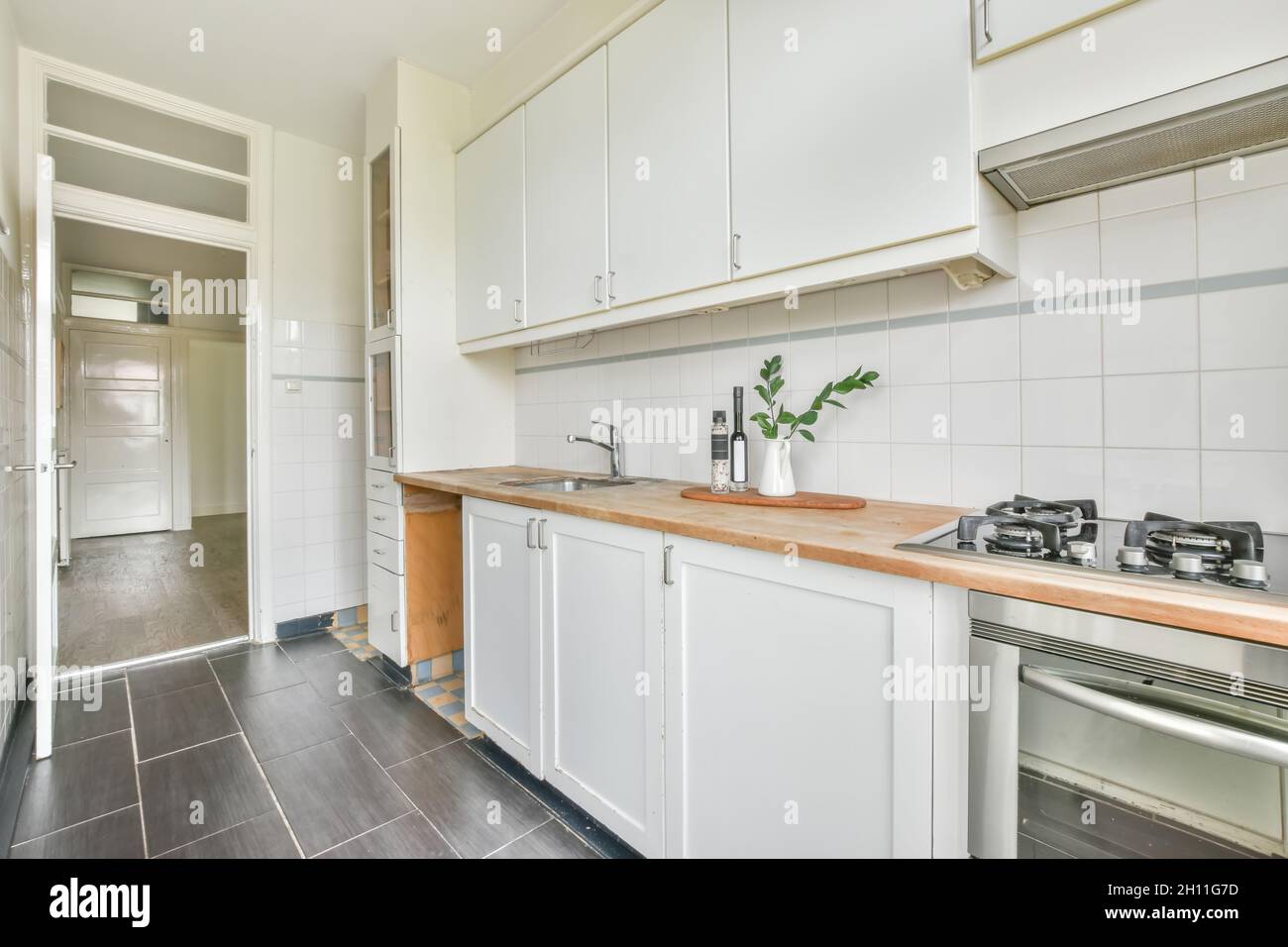 Cozy light kitchen with white furniture Stock Photo - Alamy