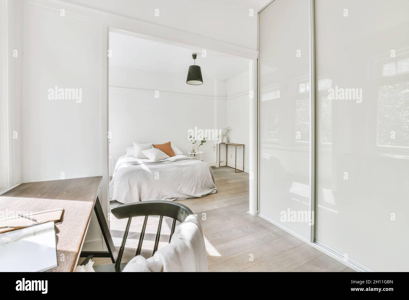 Cozy light bedroom with a working zone Stock Photo Alamy