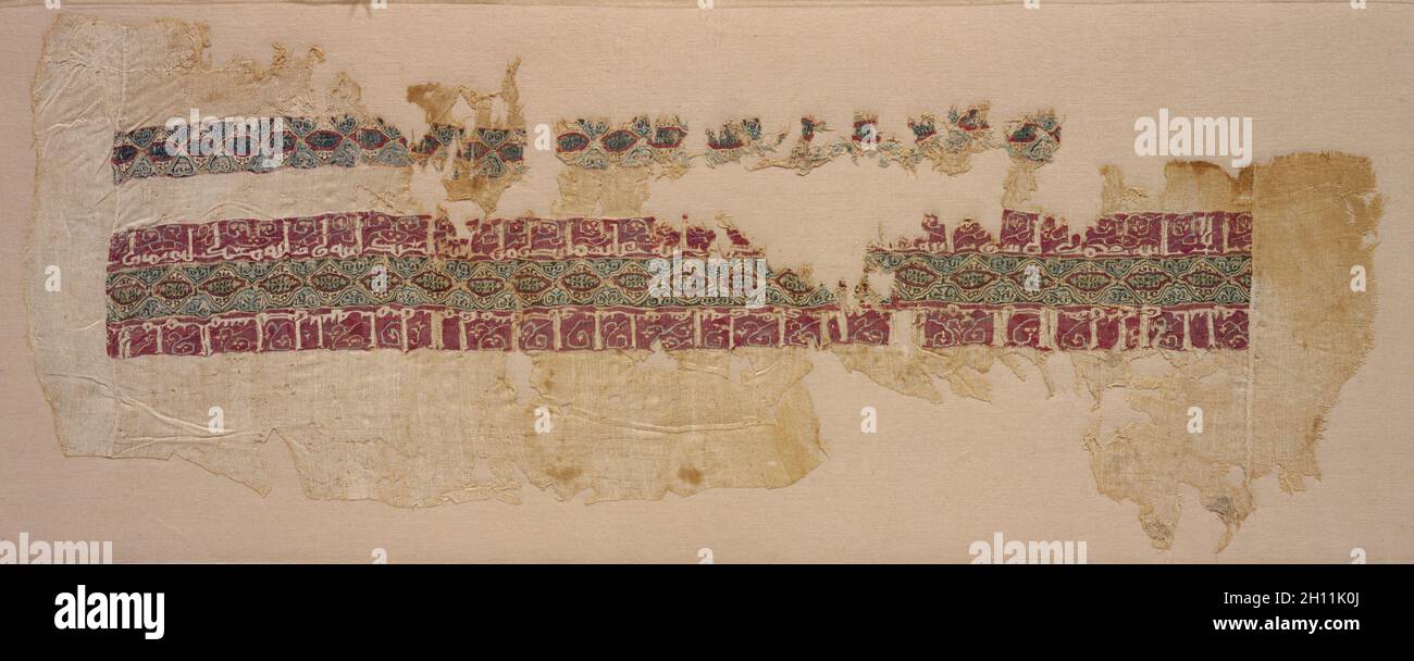 Sleeve with tiraz, 1045 - 1058. Egypt, Fatimid period, reign of Caliph al-Mustansir, 1045-58. Plain weave with inwoven tapestry weave: linen and silk; overall: 20.3 x 51.8 cm (8 x 20 3/8 in.). Stock Photo