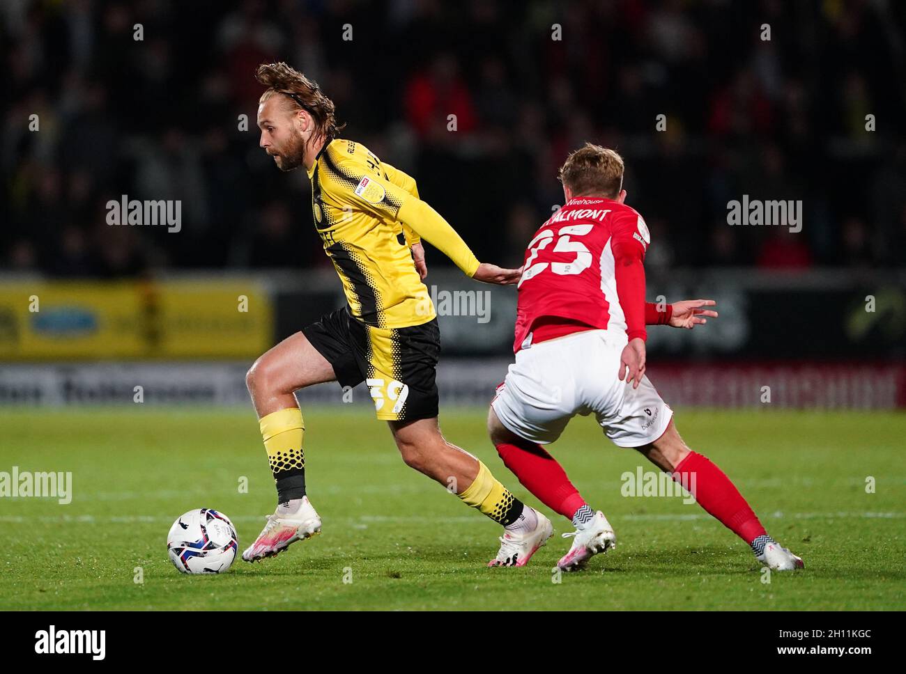 Burton Albion's Harry Chapman (left) and Morecambe's Alfie McCalmont battle for the ball during the Sky Bet League One match at the Pirelli Stadium, Burton upon Trent. Picture date: Friday October 15, 2021. Stock Photo