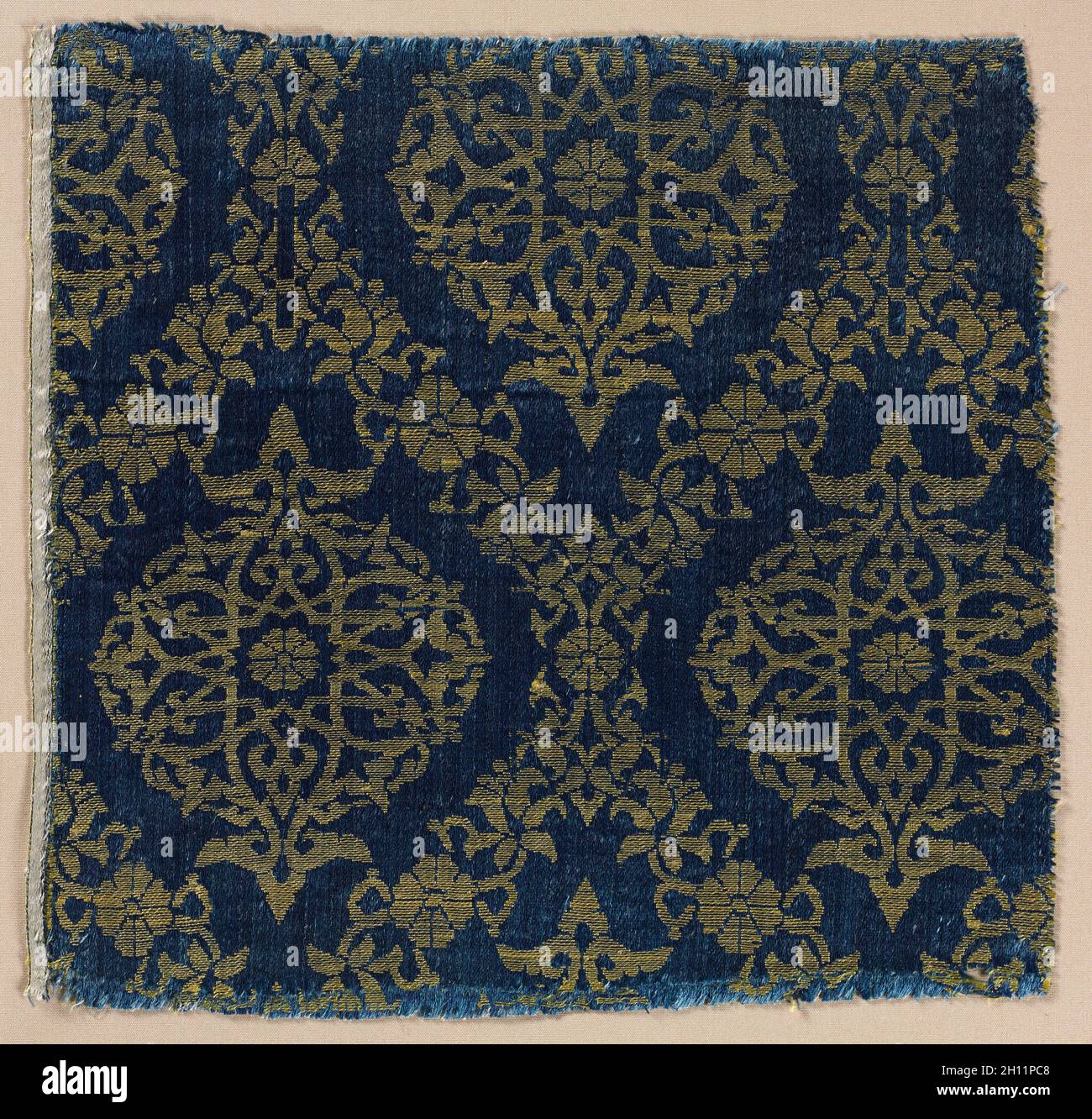 Lampas with foliate medallions in ogival lattice, 1400s. Egypt. Lampas: silk; overall: 21.6 x 22.3 cm (8 1/2 x 8 3/4 in.). Stock Photo