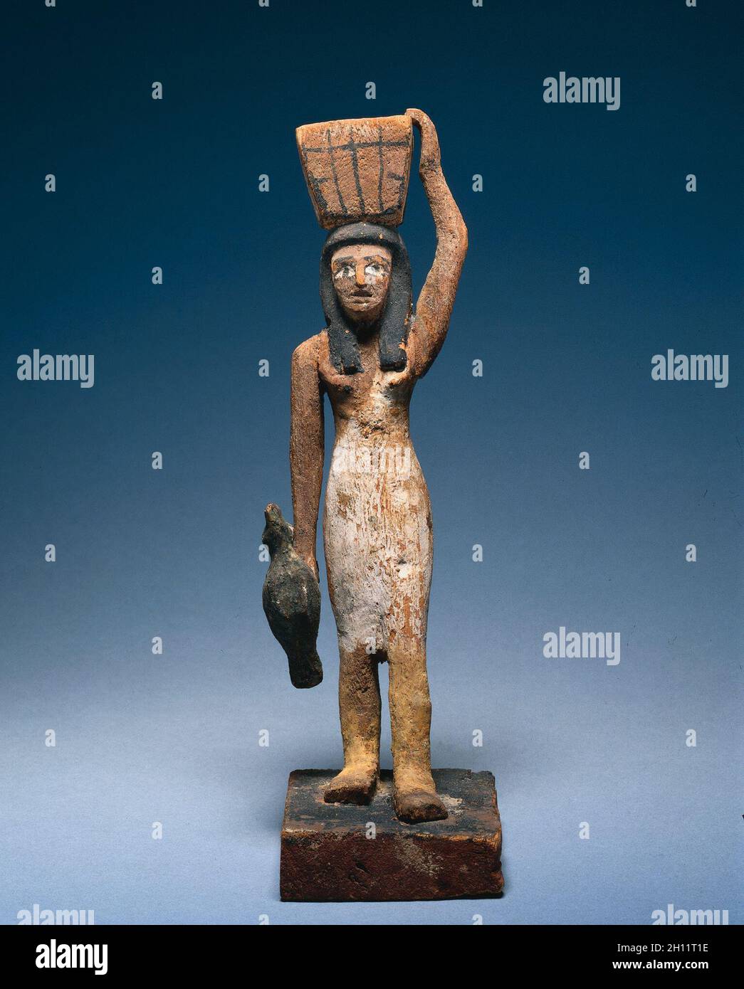 Female Offering Bearer, 2000-1801 BC. Egypt, Middle Kingdom, late Dynasty 11 to early Dynasty 12. Painted wood, figure of tamarisk (?), base of sycamore fig; overall: 25.8 x 7.9 x 12.2 cm (10 3/16 x 3 1/8 x 4 13/16 in.). Stock Photo