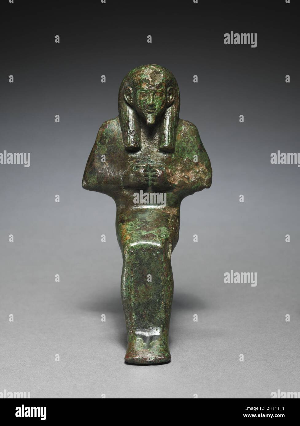 Statuette of Seated God, probably Osiris-lah, 664-525 BC. Egypt, Late Period, Dynasty 26 or later. Bronze, solid cast; overall: 15.7 x 7 x 8 cm (6 3/16 x 2 3/4 x 3 1/8 in.). Stock Photo