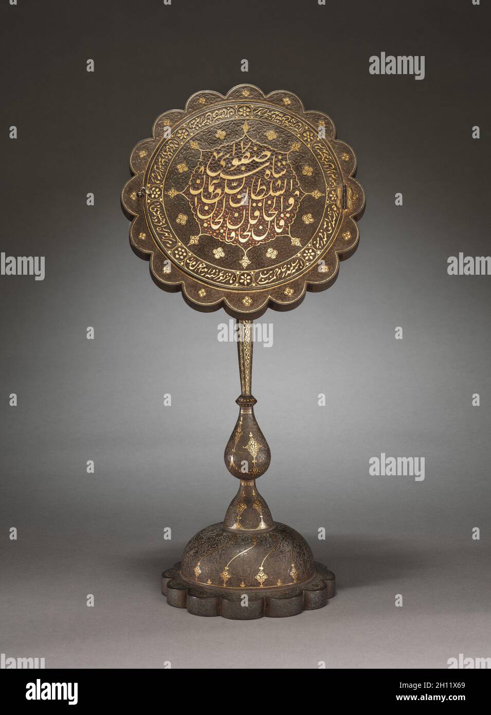 A PAIR OF LARGE QAJAR ENGRAVED BRASS CANDLESTICKS, IRAN, 19TH CENTURY