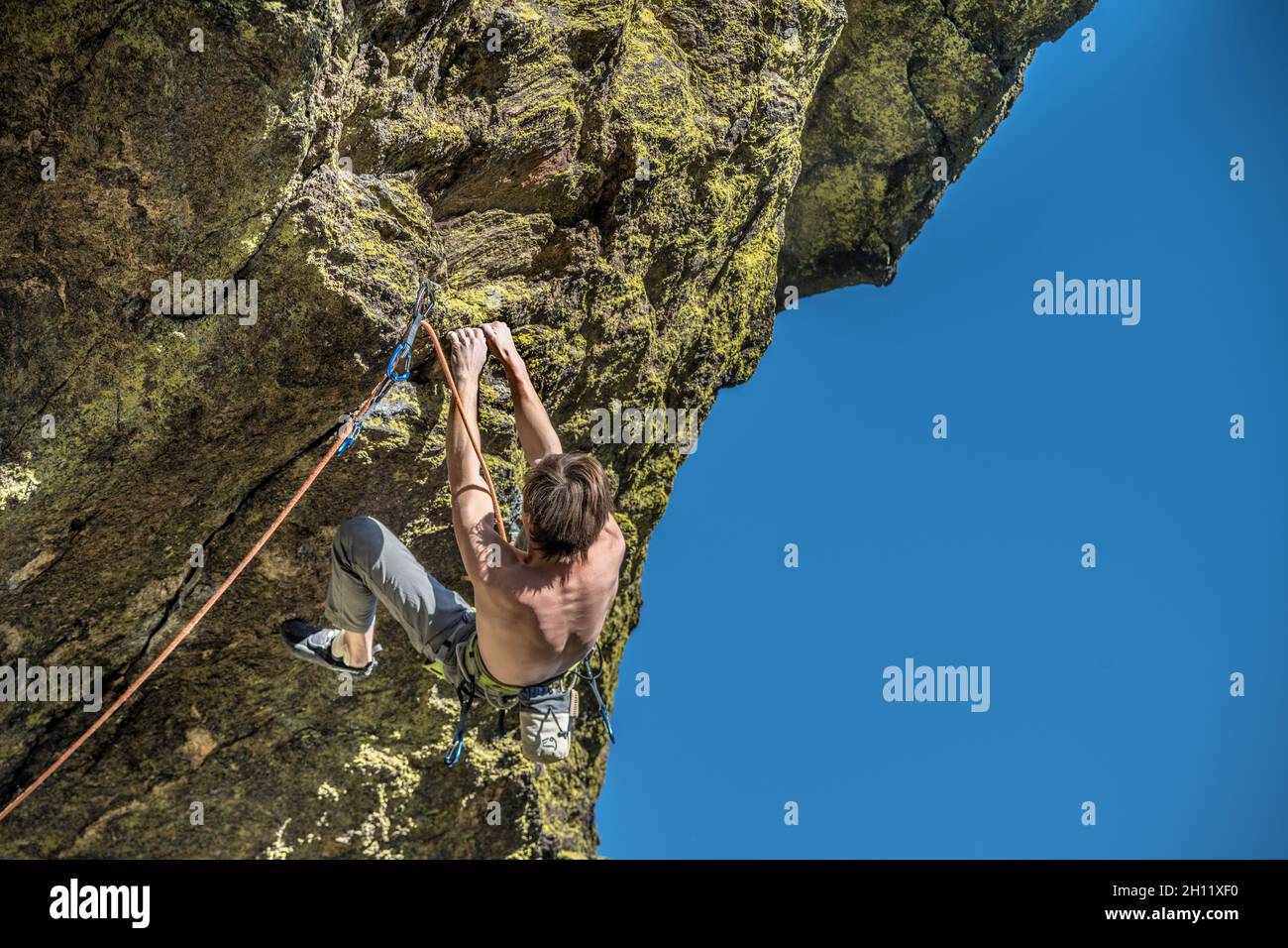 man climbing up the mountain Stock Photo