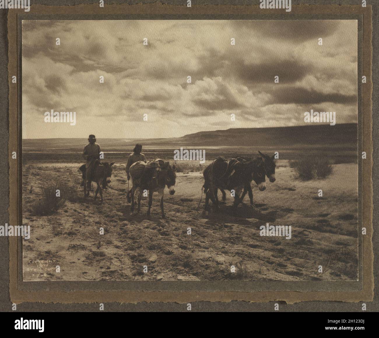 Moki Men and Burros on the Road, 1900. Edward S. Curtis (American, 1868-1952). Platinum print; image: 14.5 x 18.6 cm (5 11/16 x 7 5/16 in.); matted: 35.6 x 45.7 cm (14 x 18 in.). Stock Photo