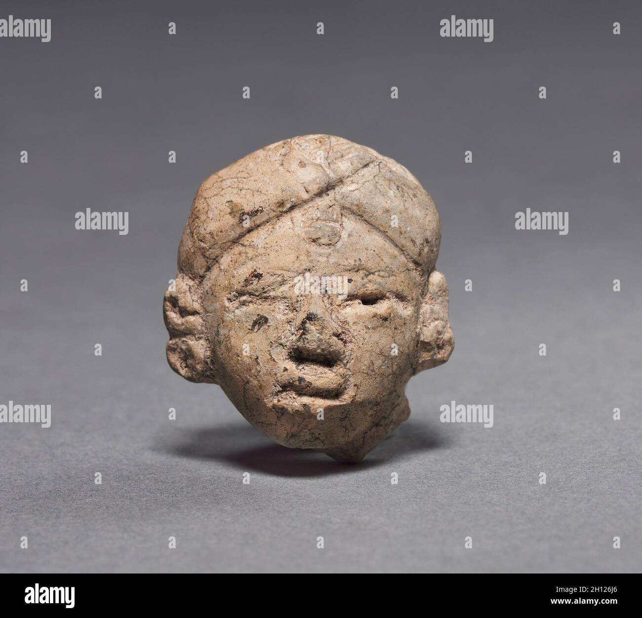 Figurine Head, c. 600-200 BC. Mexico or Central America, Maya(?), Middle Preclassic period. Pottery; overall: 3.1 x 2.6 x 1.9 cm (1 1/4 x 1 x 3/4 in.). Stock Photo