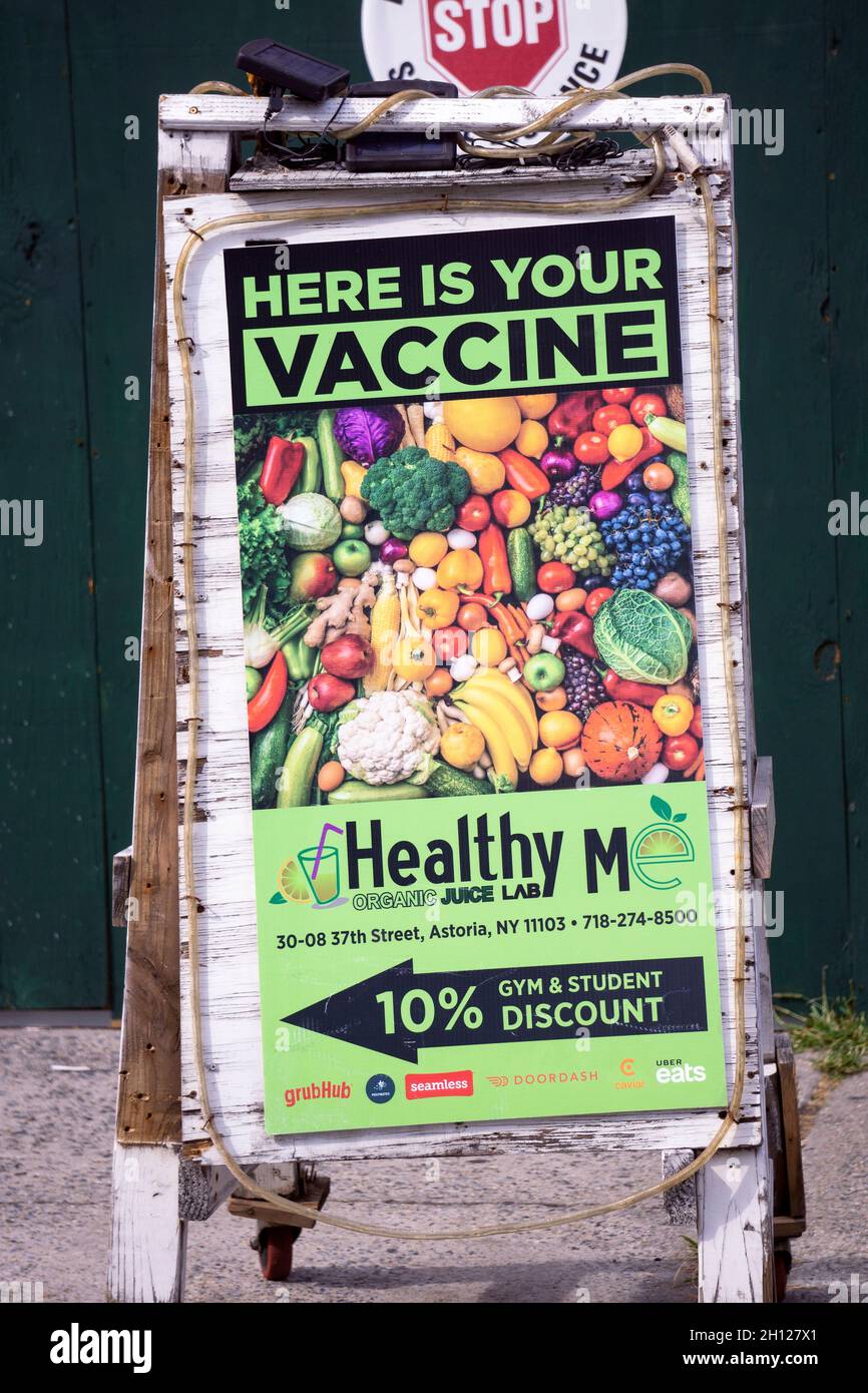 An ad for the Healthy Me juice bar and restaurant implying that a healthy diet will prevent illness. In Astoria, Queens, New York City. Stock Photo
