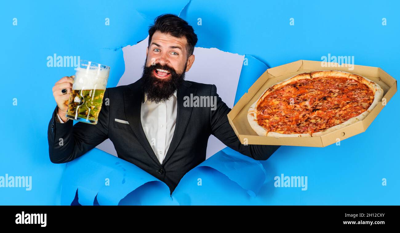 Restaurant or pizzeria. Smiling man with pizza and beer looking through ...