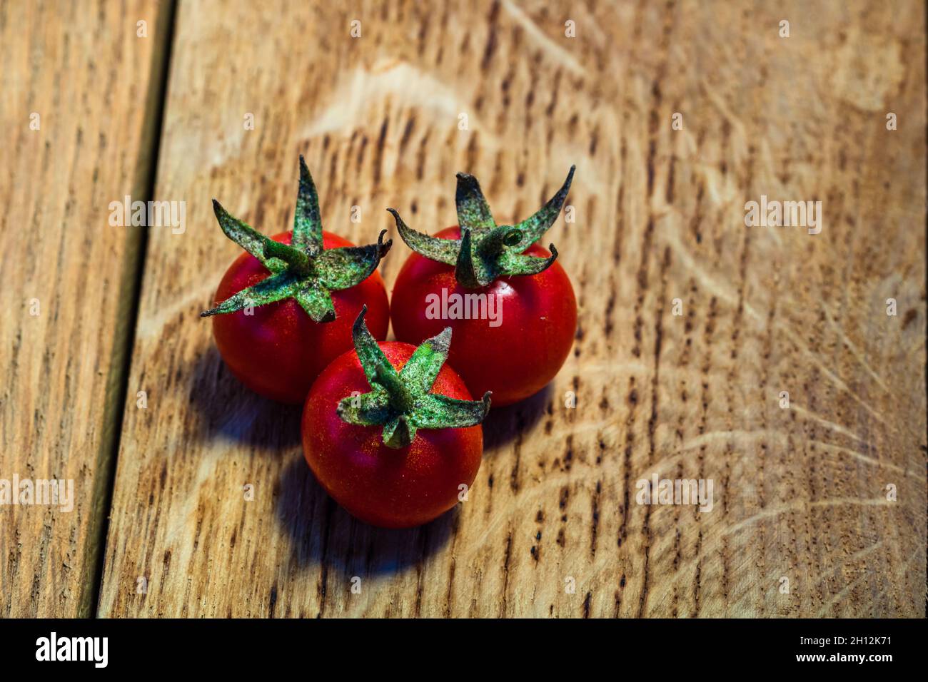 Fresh cherry tomatoes on rustic wooden background Stock Photo - Alamy