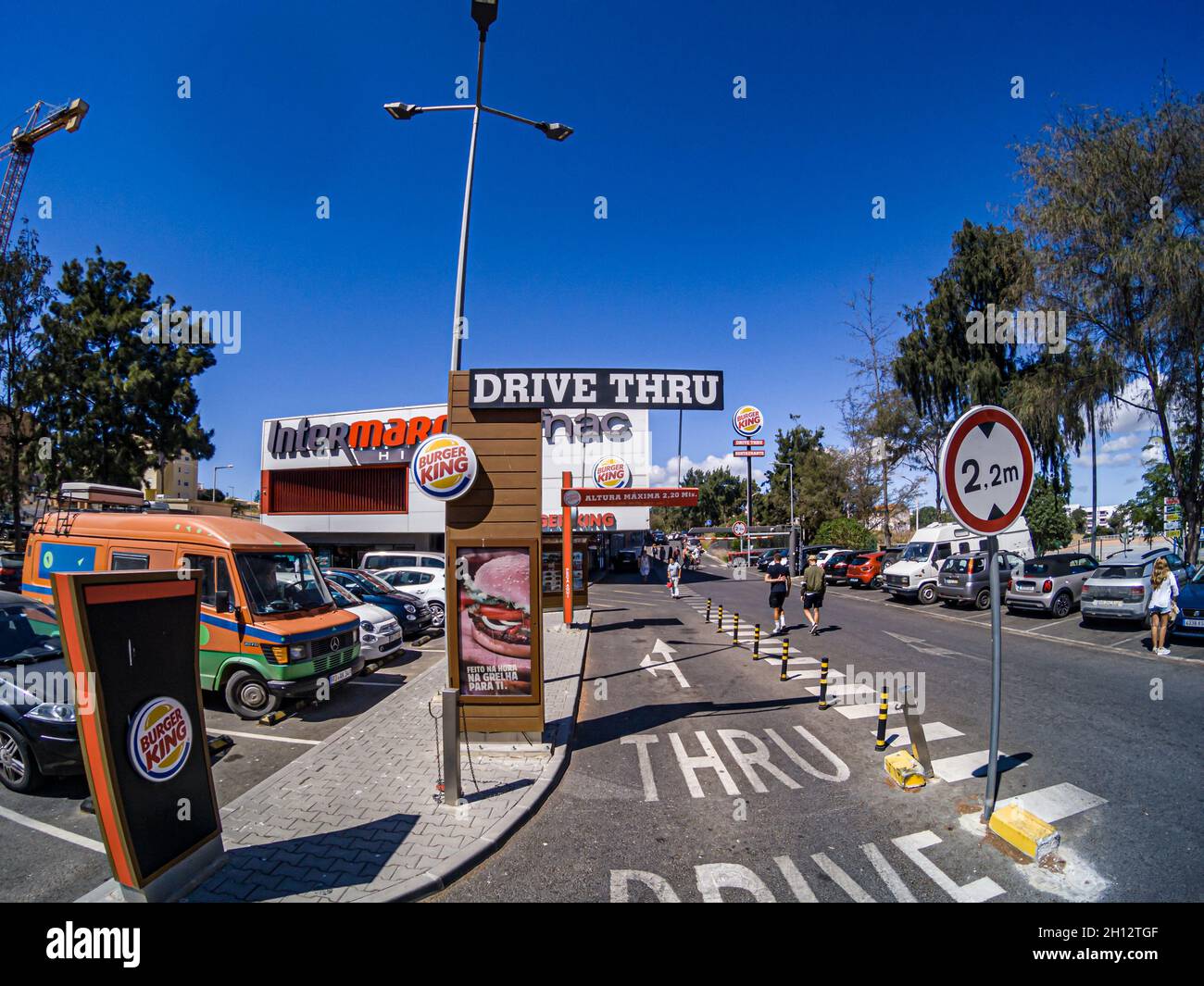 LAGOS, PORTUGAL - Sep 23, 2021: BURGER KING Drive-thru entrance signage with the branded exterior front of a Portuguese shopping center, Lagos, Portug Stock Photo