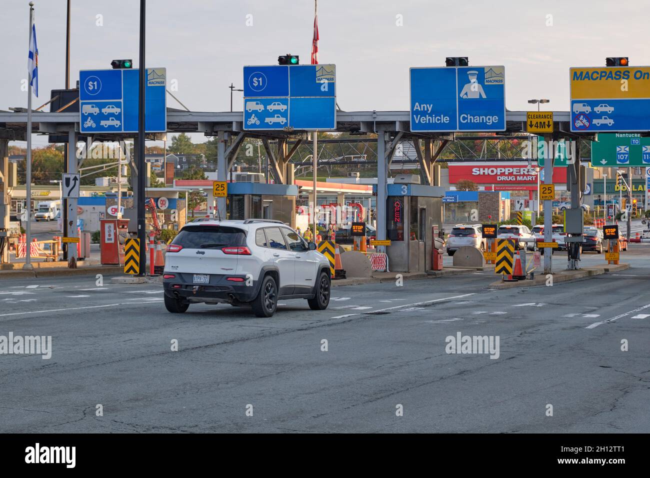 Car pulling up at the Toll Booth on McDonald Bridge over Halifax Harbour. Darmouth, Canada Stock