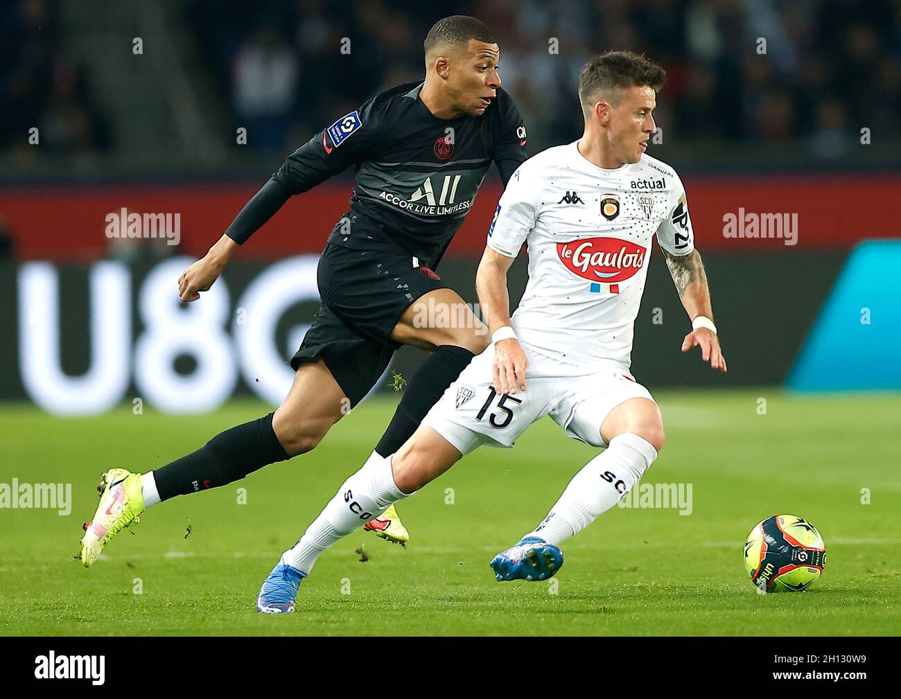 Paris, France. 16th Oct, 2021. Paris Saint Germain's Kylian Mbappe (L) competes with Pierrick Capelle of Angers SCO during a French Ligue 1 football match between Paris Saint Germain (PSG) and Angers SCO in Paris, France, Oct. 15, 2021. Credit: Xinhua/Alamy Live News Stock Photo